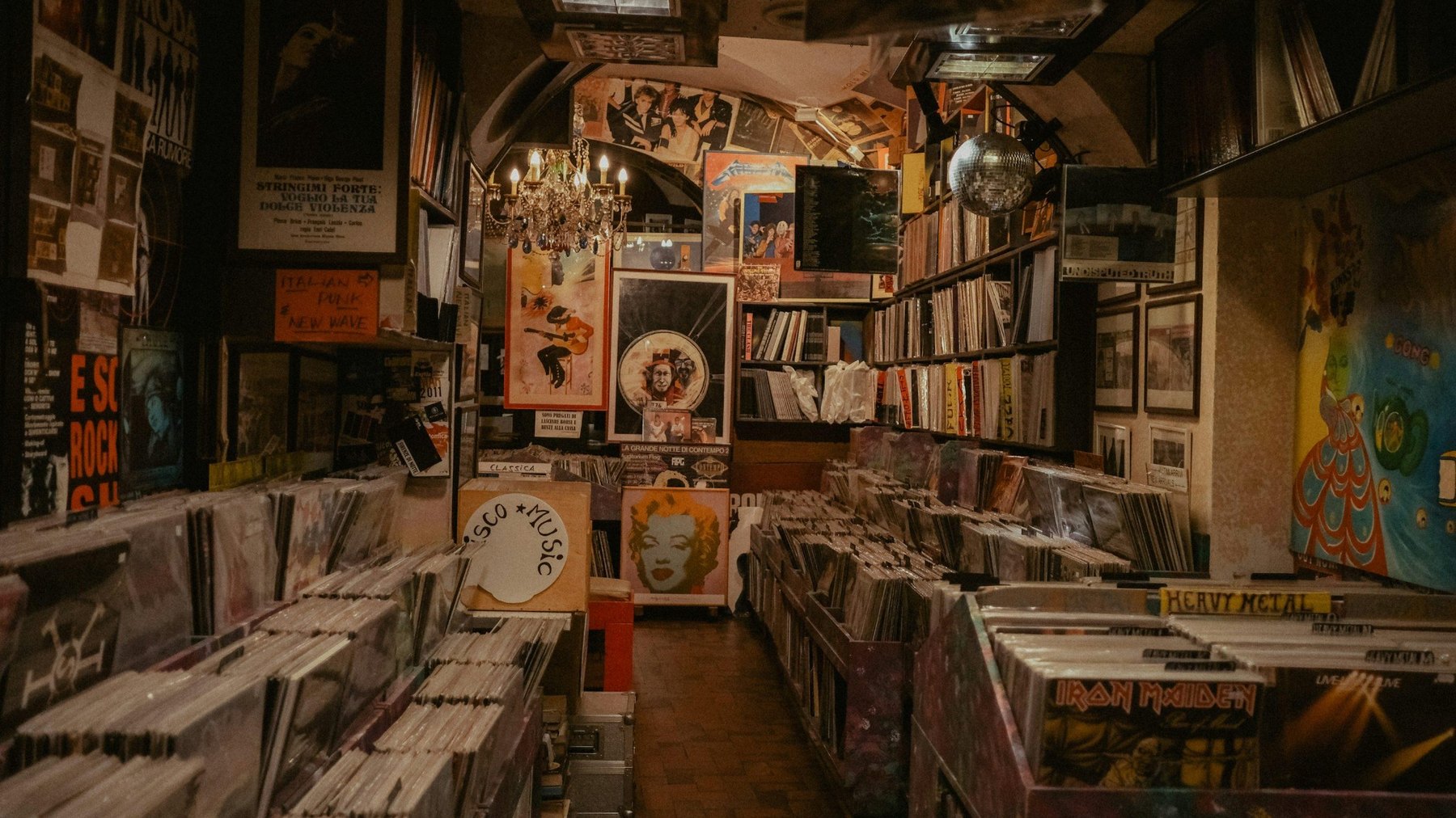 Dimly lit record shop filled with vinyl albums and music posters