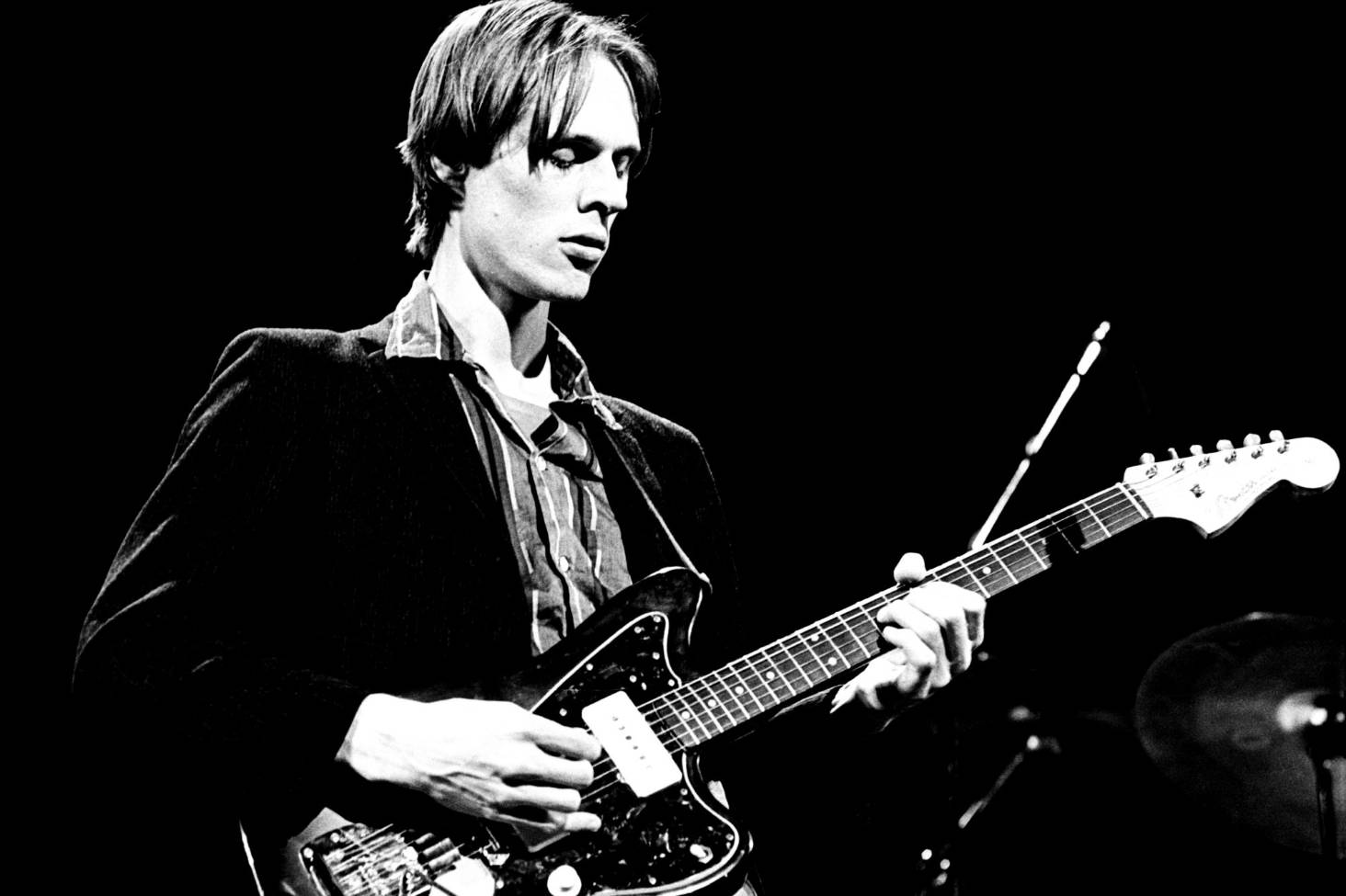 Electric guitar neck and strings in dramatic stage lighting