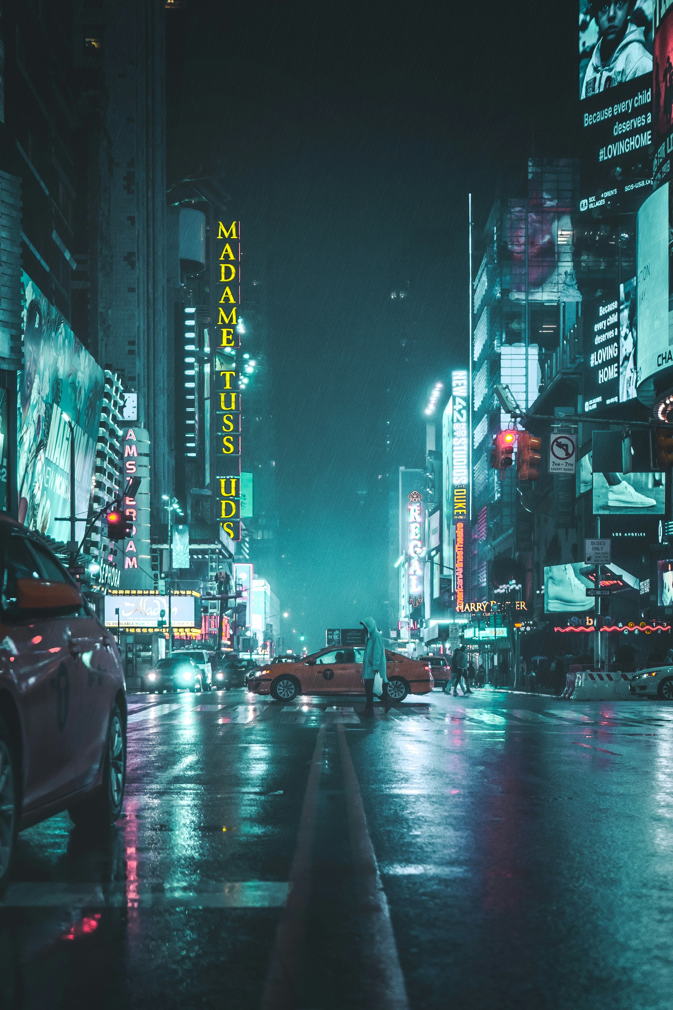 Urban street at night with neon lights reflected in rain